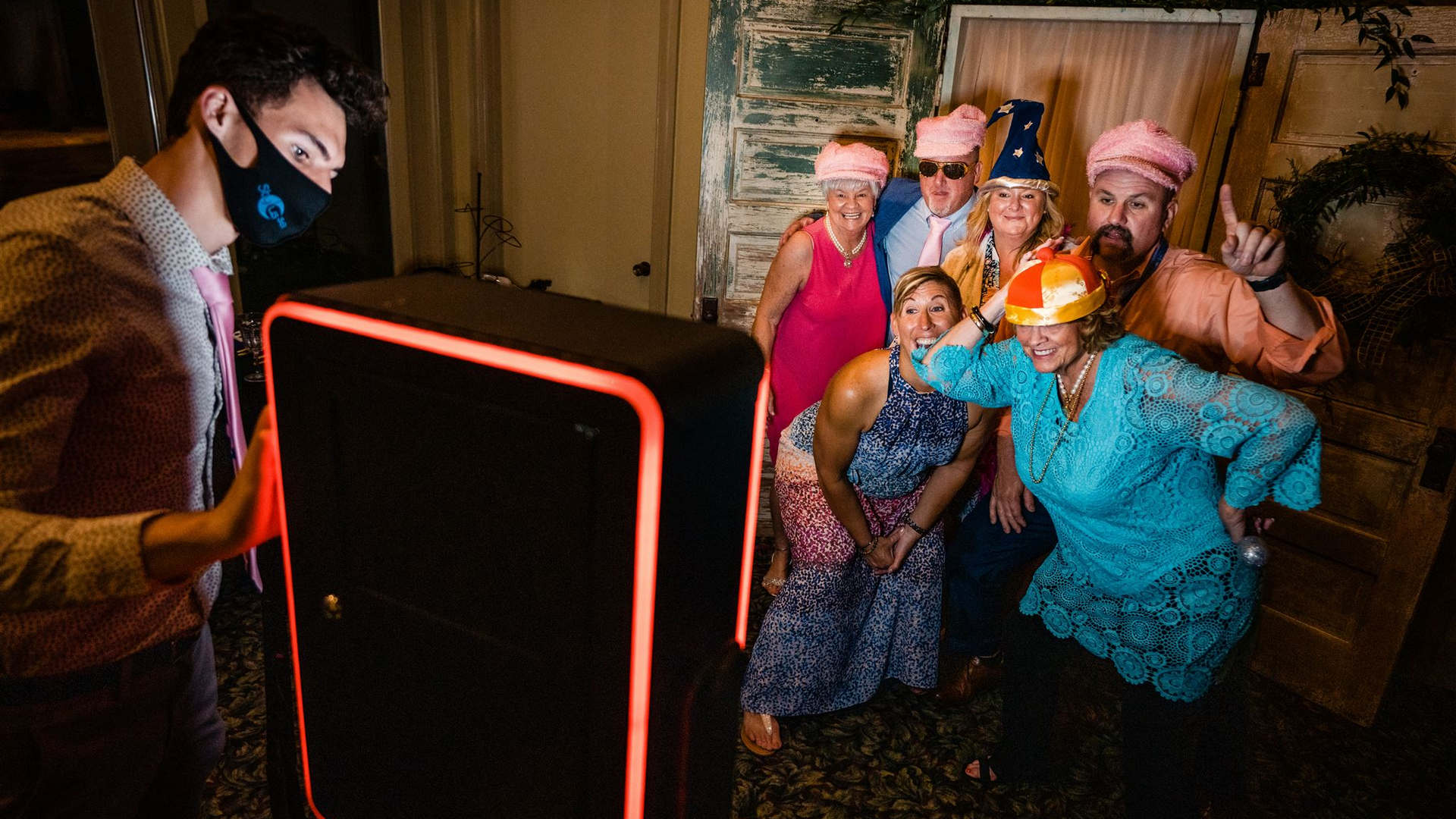 Wedding guests posing with props at a photo booth.